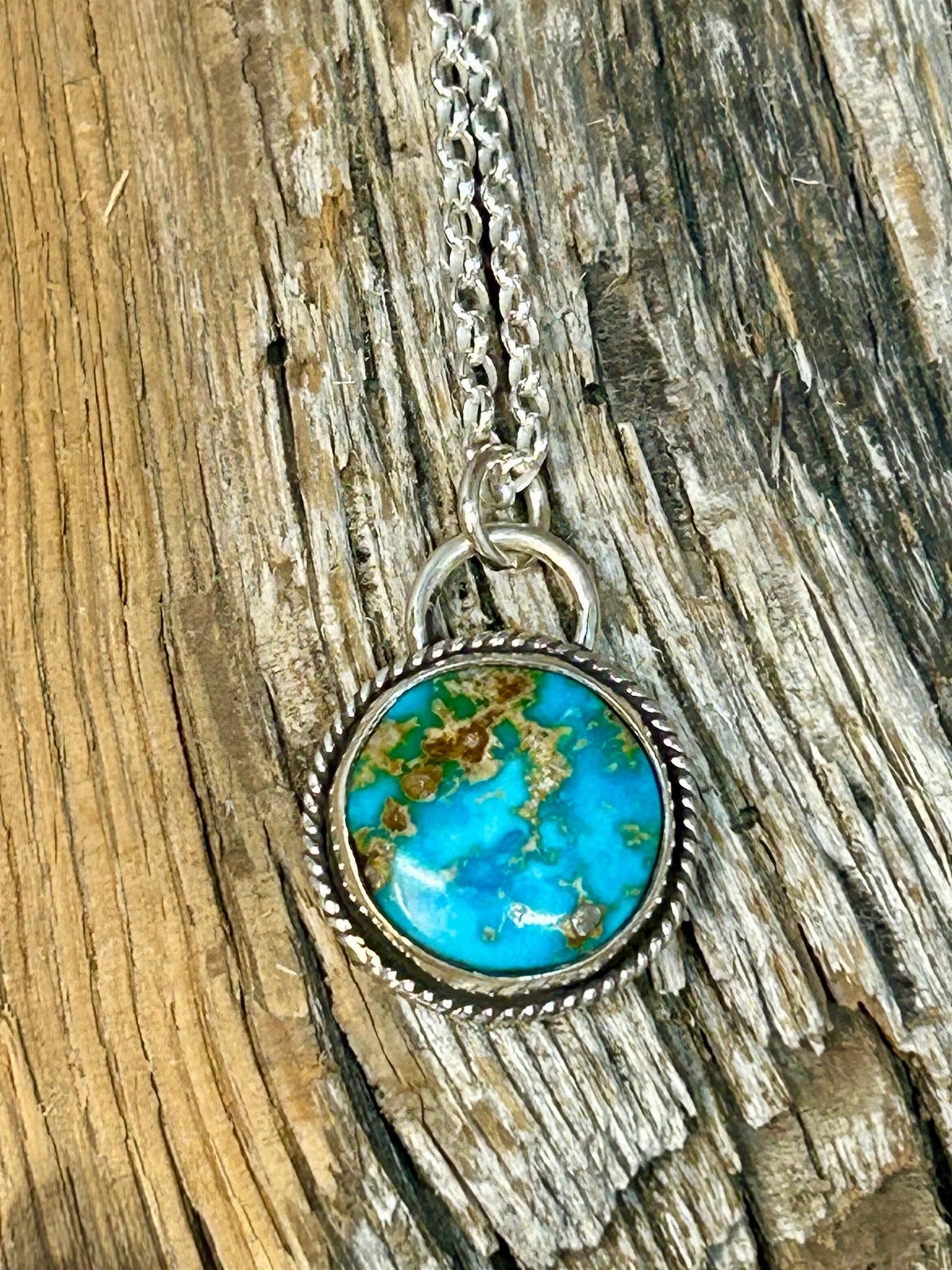 This Sierra Bella turquoise cabochon is set in a simple sterling silver setting with a thin silver twist wire. This necklace is 18 inches long.
