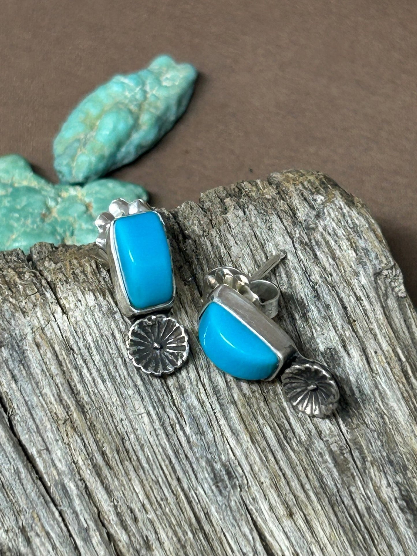 These Sleeping Beauty cabochons are set in sterling silver accented with silver flowers with silver posts and ear backs.