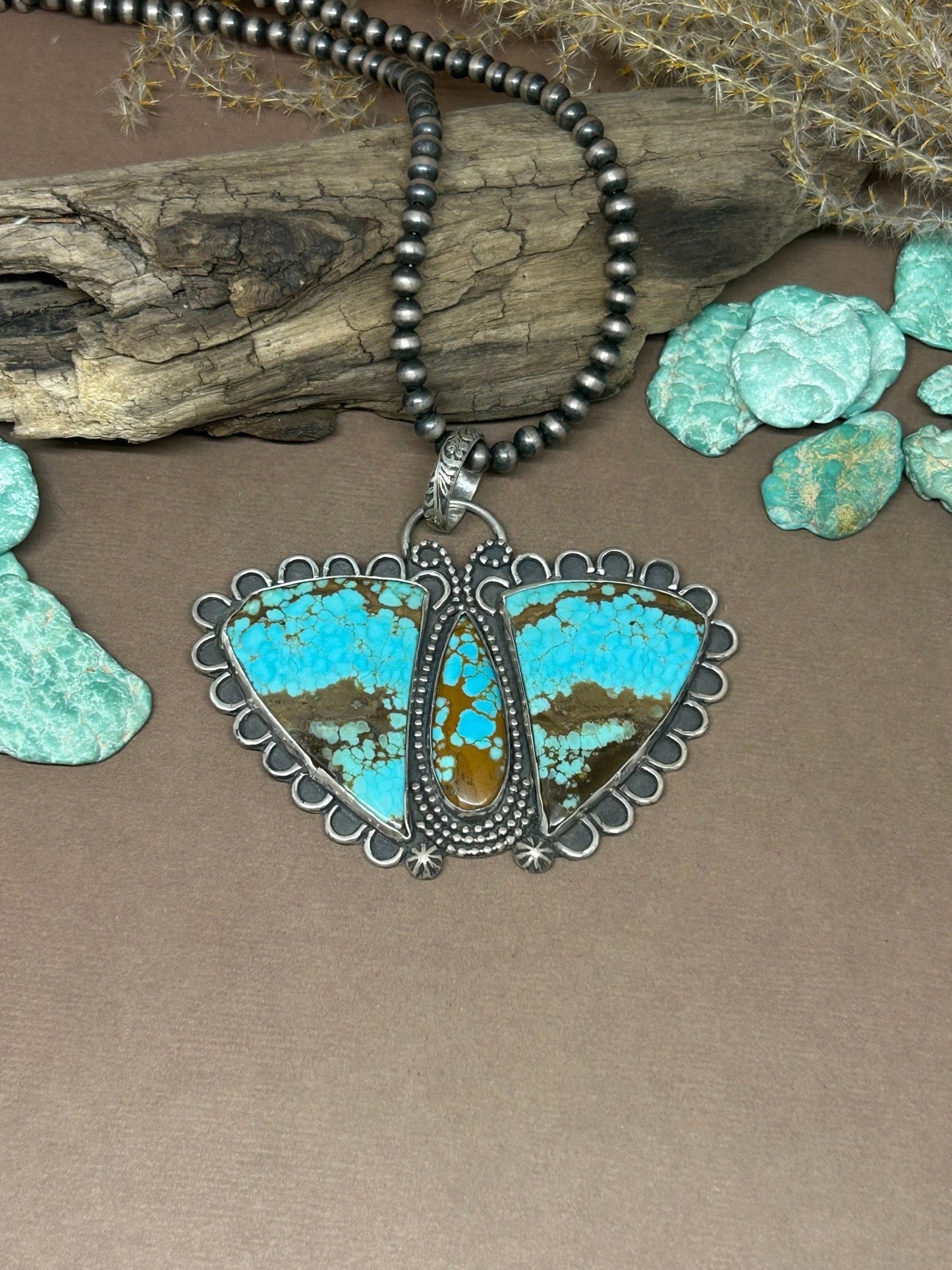 This Mine number 8 turquoise is set in a solid sterling silver butterfly setting.