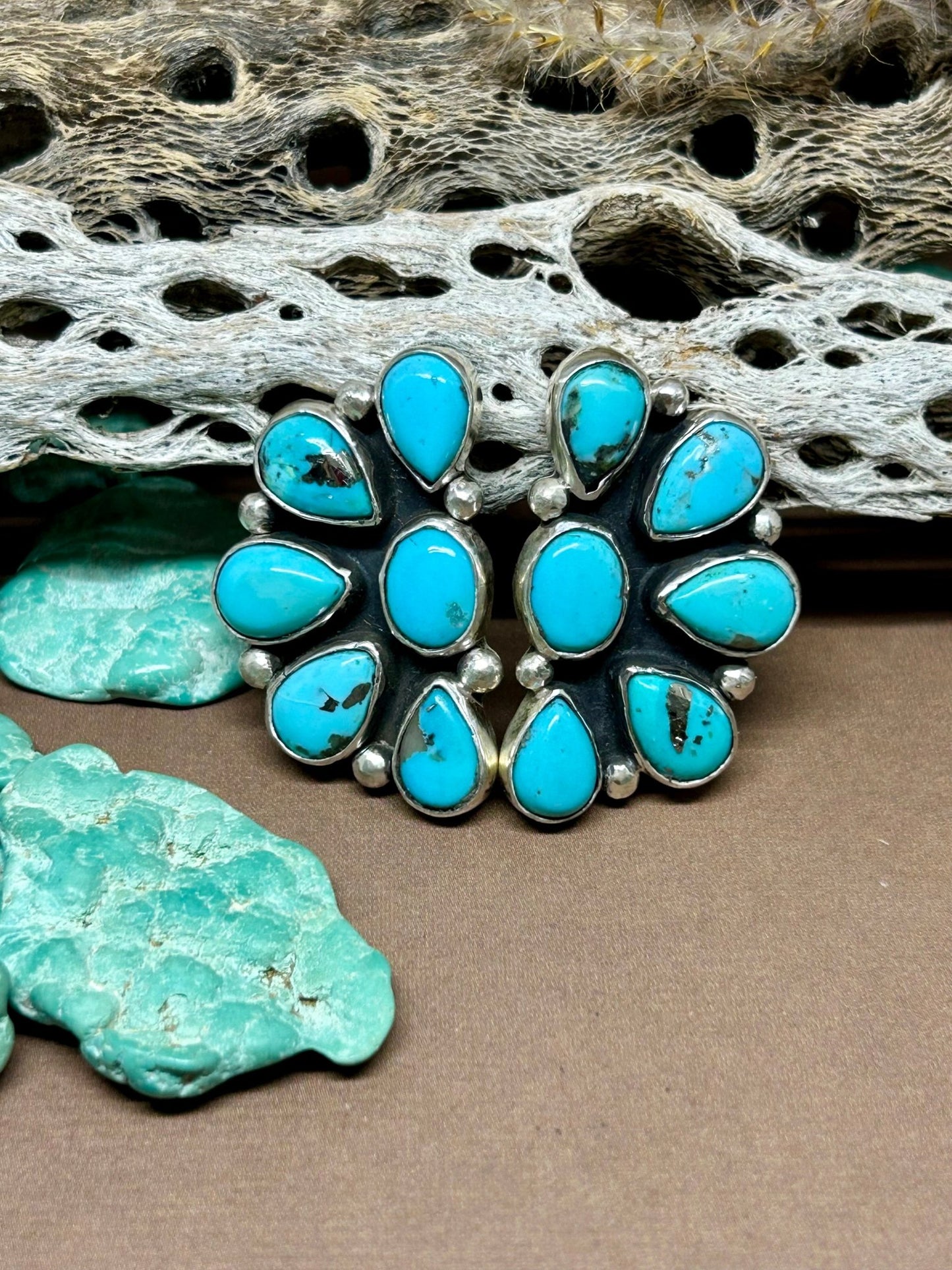 These turquoise cluster sterling silver stud earrings are made with persian turquoise set in sterling silver with sterling ear posts and backs.