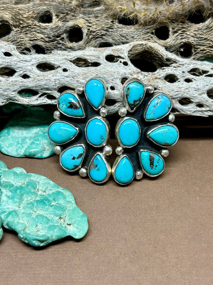 These turquoise cluster sterling silver stud earrings are made with persian turquoise set in sterling silver with sterling ear posts and backs.
