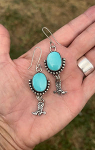 Kingman titquoise set in sterling silver accented with bead wire and silver cowboy boots. Handmade by Taylor made Silver.