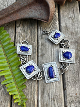 Load image into Gallery viewer, Five lapis stones set in sterling silver set on two plates of sterling silver with a soft patina.  This sterling silver link bracelet is just over 8 inches with a toggle clasp.  Handmade by Taylor Made Silver.
