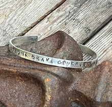Load image into Gallery viewer, Hand stamped sterling silver affirmation cuff.  handstamped with the words strong, brave, courageous, amazing, unbroken.
