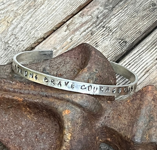 Hand stamped sterling silver affirmation cuff.  handstamped with the words strong, brave, courageous, amazing, unbroken.